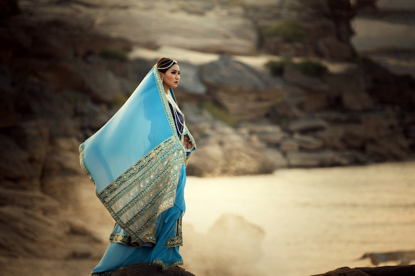 Portrait woman wearing Iran or Arab traditional dress standing on sand riverside